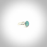 This is a handcrafted real opal ring with sterling silver. The colours are a gorgeous turquoise blue. This is a solid little work of art. We ship this worldwide for free and are happy to answer any questions that you may have about these or other products on our website.